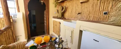 a kitchen with a table with oranges on it at Riad Ayada in Marrakech