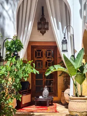 a room with a table and some plants at DAR CHIBANIA in Marrakech