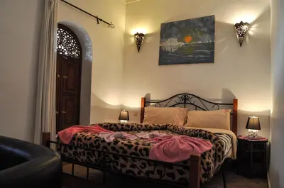 a bedroom with a bed in a room at Riad Mandalay in Marrakech