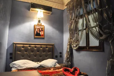 a bedroom with a bed with a heart on it at Riad Fattouma Kasba in Marrakech