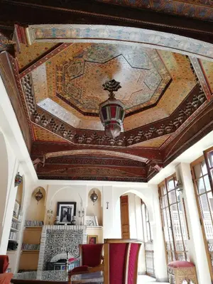 a room with a ceiling with a painting on it at Riad Ben Youssef in Marrakech