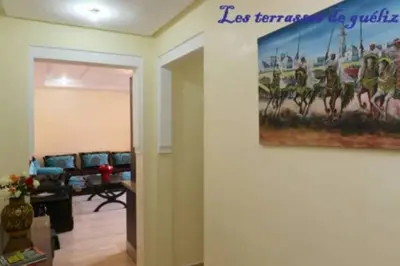 a living room with a painting on the wall at Les terrasses de Gueliz in Marrakech
