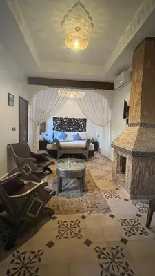 a living room with a couch and a fireplace at Oloft in Marrakech