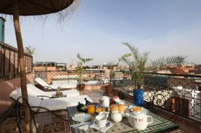 a table and chairs on a balcony with a view at Sindi Sud in Marrakech
