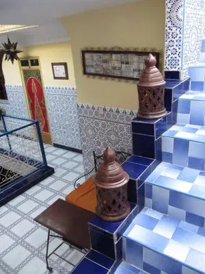 a room with blue and white tiles on the floor at Sindi Sud in Marrakech