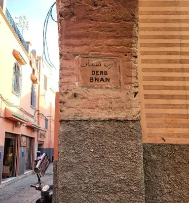 a street sign on the side of a building at house miss rose in Marrakech