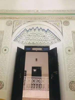 a room with two doors and a balcony at Riad Dialna in Marrakech
