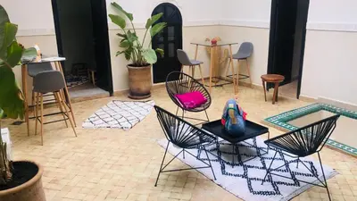 a room with two chairs and a table and chairs at Riad Dialna in Marrakech
