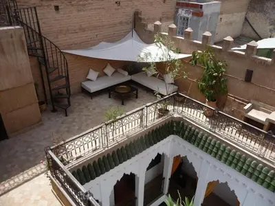 an overhead view of a balcony with a couch and a table at Riad Dialna in Marrakech