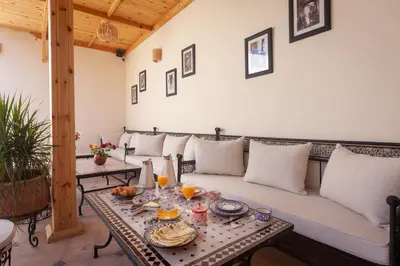 a living room with a couch and a table at Riad Salman in Marrakech