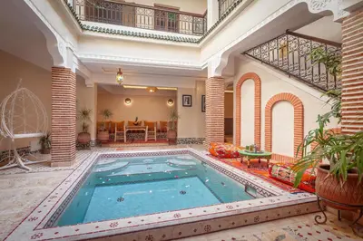 a large swimming pool in a large building at Riad Salman in Marrakech