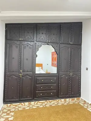 a room with black cabinets and a mirror at Riads Dar ZAO - logements entiers in Marrakech