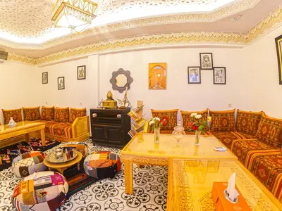 a living room with couches and a table at Riad Dar Yassine in Marrakech