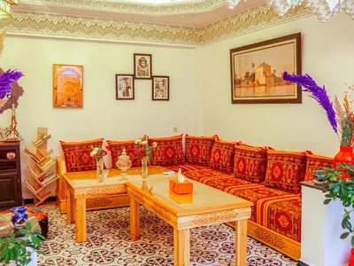 a living room with a red couch and a table at Riad Dar Yassine in Marrakech