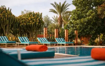 a pool with lounge chairs and a swimming pool at Jnan Lotf Marrakech - Le Jardin de la Bienveillance in Marrakech
