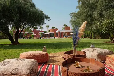 a group of picnic tables in a park at Villa LOULA in Marrakech