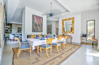 a dining room with a table and chairs at Villa ZITOUNA in Marrakech