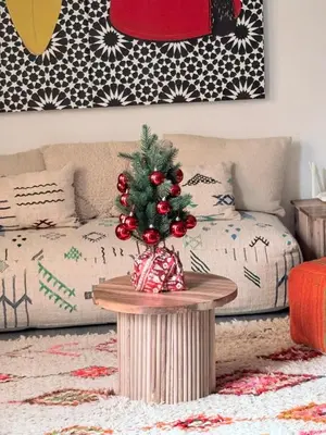 a christmas tree on a table in a living room at 