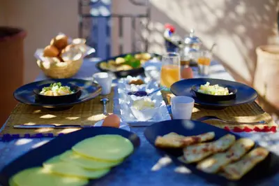 a blue table with plates of food on it at AZ RIAD in Marrakech