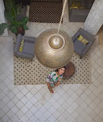 an overhead view of a woman standing in a living room at AZ RIAD in Marrakech