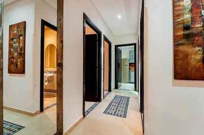 a hallway with two mirrors and a blue rug at Majorelle Garden Retreat 2BR Apartment Near Jardin Majorelle in Marrakech