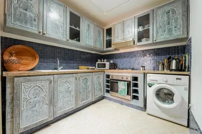 a kitchen with a washer and dryer in it at Majorelle Garden Retreat 2BR Apartment Near Jardin Majorelle in Marrakech