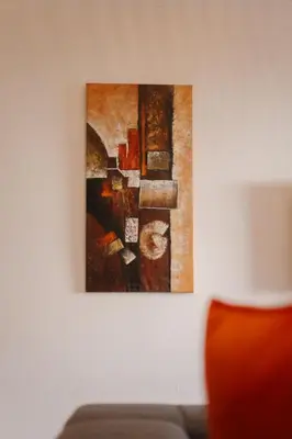 a painting hanging on a wall next to a couch at Majorelle Garden Retreat 2BR Apartment Near Jardin Majorelle in Marrakech