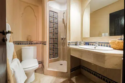 a bathroom with a toilet and a sink and a shower at Majorelle Garden Retreat 2BR Apartment Near Jardin Majorelle in Marrakech