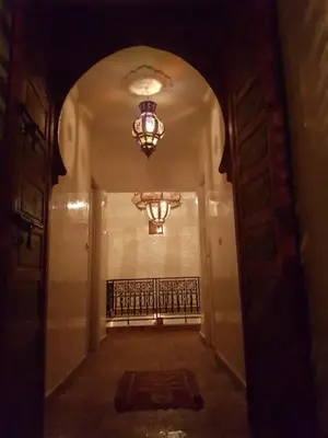 an empty hallway with a chandelier in a building at Riad Al Jawhar in Marrakech