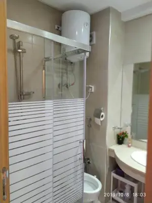 a bathroom with a shower and a toilet and a sink at Superbe appartement Hivernage in Marrakech