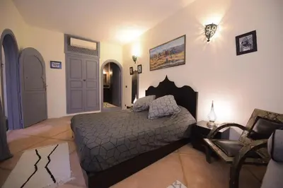 a bedroom with a bed and a chair at 