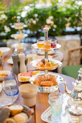 a table topped with plates of food and drinks at Hotel Jadali & Spa in Marrakech