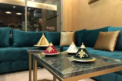 four hats on a table in a living room at Cosy Loft Emeraude Marrakech Prestigia Golf City in Marrakech