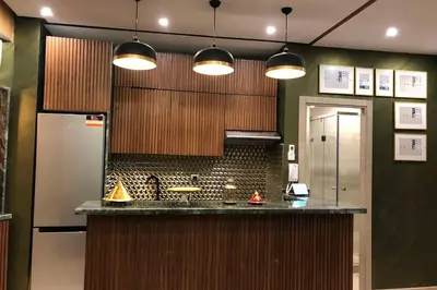 a kitchen with a counter and a refrigerator at Cosy Loft Emeraude Marrakech Prestigia Golf City in Marrakech