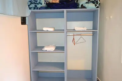 a closet with blue shelves in a room at Riad el Boukhiri in Marrakech
