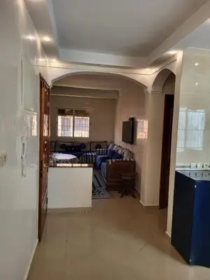 a living room with a couch and a table in a room at 90 qm Wohnung mit 2 Schlafzimmern in Marrakech