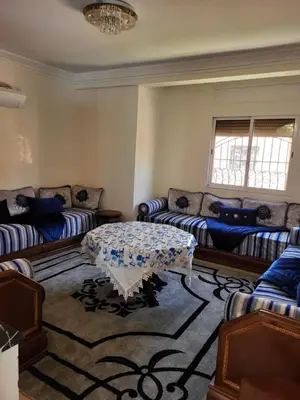 a living room with couches and a table in it at 90 qm Wohnung mit 2 Schlafzimmern in Marrakech