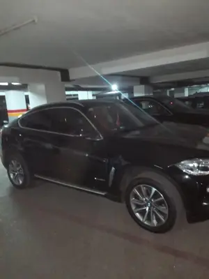 a black car parked in a parking garage at Luxury apartment in the heart of Gueliz , Wifi, Pool in Marrakech