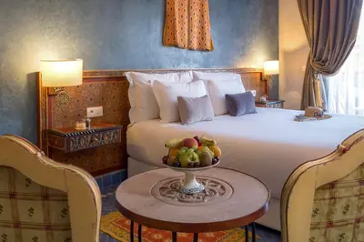 a hotel room with a bed and a bowl of fruit on a table at dar al walidine in Marrakech