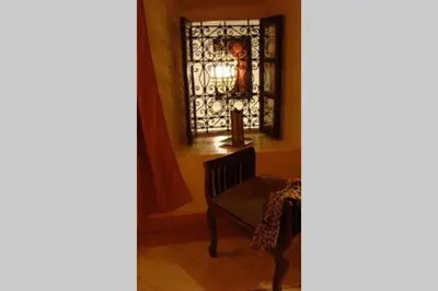 a room with a chair and a stained glass window at Emplacement N°1 ! RIAD ICA (EN EXCLUSIVITE) in Marrakech