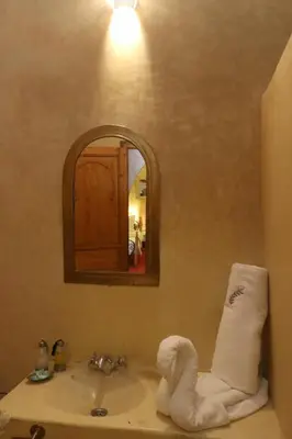 a bathroom with a sink with a towel on it at Riad Maissoun in Marrakech