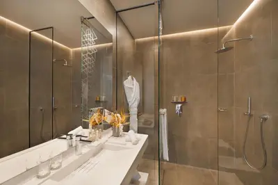 a bathroom with a shower and a sink and a mirror at Pestana CR7 Marrakech in Marrakech