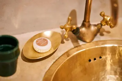a bathroom counter with a sink with a cup and a soap dish at Riad Algora en exclusivité 13 P au cœur de la Médina in Marrakech