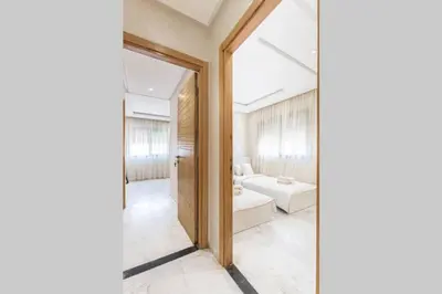 a room with a door leading to a living room at LUXURY APARTMENT IN THE HEART OF MARRAKECH GUELIZ in Marrakech