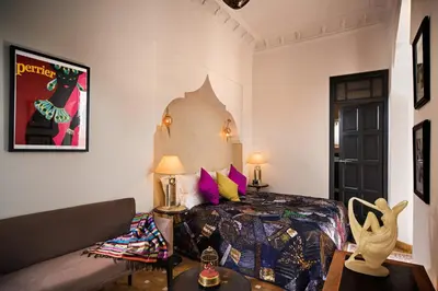 a bedroom with a bed and a couch in a room at Riad Star by Marrakech Riad in Marrakech