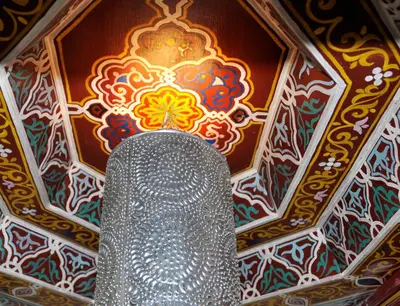 a chandelier in a room with a painting at Riad l'Escale de Marrakech in Marrakech