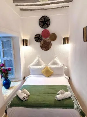 a bedroom with a bed with towels on it at Riad Green Palm in Marrakech