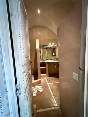 a hallway of a room with a mirror and a door at Riad Green Palm in Marrakech