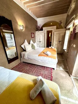 a bedroom with two beds in a room at Riad Green Palm in Marrakech