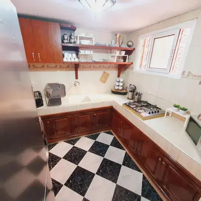 a kitchen with a black and white checkered floor at Chez Jasmeene in Marrakech
